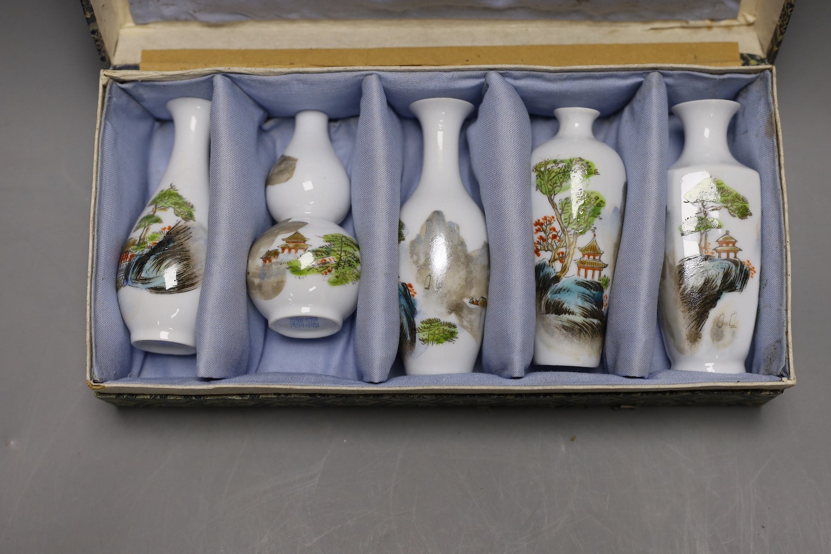 A Chinese blue and white miniature teapot, 6 matching cups and a tray and a box of five vases